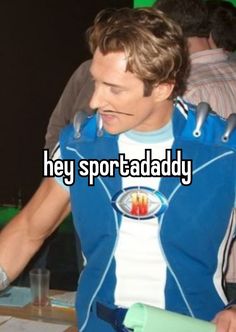 a man wearing a blue vest with the words hey sportaddy