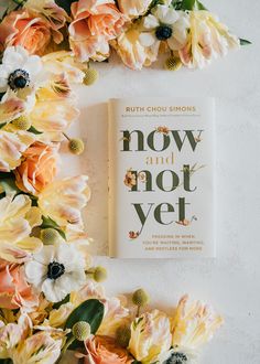 the book now and got yet is surrounded by flowers on a white surface with green leaves