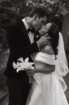 a bride and groom kissing on their wedding day