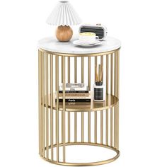 a white marble topped end table with gold metal accents and a decorative lamp on top