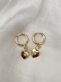 Brand new  💕Handmade by yours truly  Beautiful high quality and lead free. Huggies, charm and all findings are 18K gold plated and tarnish resistant.  COLOURGold  SIZE1.1cm diameter Huggie 0.9cm charm Material18K Plated Gold Brass Weight8.6g 💌 Price includes free untracked shipping within Australia *These earrings are made to sit front facing. Please refer to try on picture. If you prefer side facing, please leave a comment at checkout  **These huggies have an 1mm thick ear pin which may not b Gold Hoop Earrings With Heart Charm, Gold Dangle Heart Earrings With Cubic Zirconia, Gold Cubic Zirconia Heart Dangle Earrings, Gold Cubic Zirconia Dangle Heart Earrings, Gold Cubic Zirconia Earrings With Heart Charm, Gold Cubic Zirconia Heart Earrings In Dainty Style, Gold Dainty Heart Earrings With Cubic Zirconia, Dainty Gold Heart Earrings With Cubic Zirconia, Dainty Gold Hoop Earrings With Heart Charm