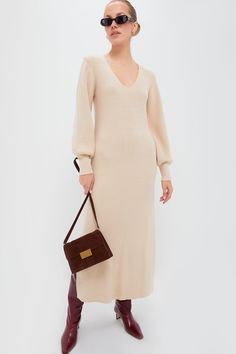 A body-hugging knit that you can wear day in and day outThe Anya Midi Dress features flirty details such as the balloon sleeves, wide V-neckline, and side slits in a neutral colorway perfect for year-round wear. We are styling this with boots and a belt for family get togethers, or with heels and a shoulder bag for casual date nights.Our Favorite Details: Fitted cuffs Soft, midweight woven fabric Pencil silhouette Material: 50% Viscose 28% Polyester 22% NylonCare: Hand wash cold, do not tumble d Elegant Neutral Sweater Dress For Fall, Elegant Cream V-neck Sweater Dress, Elegant Knit Midi Dress For Brunch, Chic V-neck Sweater Dress For Brunch, Chic Balloon Sleeve Midi Dress For Fall, Casual Date Nights, Deepa Gurnani, Pencil Silhouette, Cocktail Attire