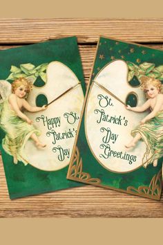 two green and gold greeting cards with an angel holding a clock on it's side