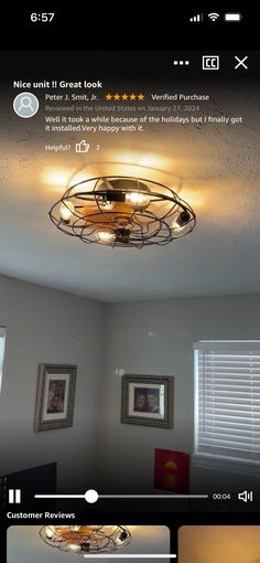 an image of a ceiling light in a room with pictures on the wall and below it