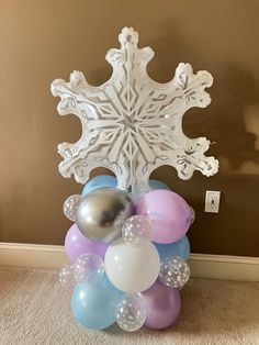 balloons and snowflakes are arranged on the floor