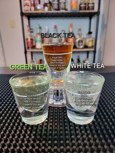 three glasses filled with different types of green tea and white tea on top of a table