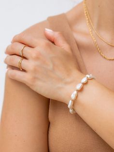 Part of our 2021 summer collection, this freshwater pearl bracelet adds a pop to any arm candy. Handcrafted with gold-filled beads and freshwater pearls, be sure to stand out this summer with our Costa collection. Compliment with the matching necklace and anklet. Waterproof & tarnish resistant Freshwater pearls may vary in size/shape/color Pearl Anklet, Detailed Jewelry, Gold Bead Bracelets, Freshwater Pearl Bracelet, Matching Necklaces, Arm Candy, Baroque Pearls, Gold Beads, Pearl Bracelet