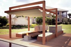 a wooden bench sitting on top of a hard wood floor next to a fire pit