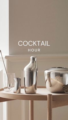 an advertisement for cocktail hour with bottles and glasses on a table in front of a white wall