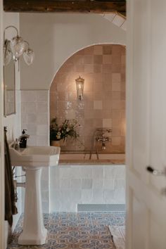 a bath room with a toilet a sink and a bath tub