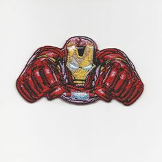 an iron man embroidered patch on a white background