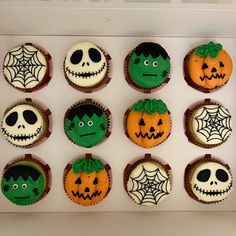 twelve halloween cupcakes decorated with green and orange frosting