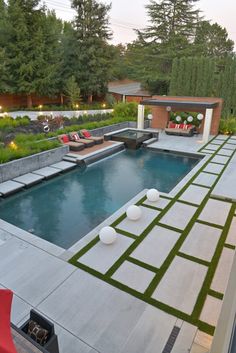 an outdoor swimming pool surrounded by grass