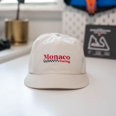 Made in Sacramento, California Featuring 'Monaco Racing', this light weight, mid profile hat is perfect for both men and women that are fans of Formula 1 and Monaco Racing. Constructed with a mid profile and a plastic snapback enclosure with a flat/slight curve visor, this hat offers an adjustable fit and ensures comfort throughout the day, whether your cheering on your favorite driver on track or running errands. Suitable as part of an everyday outfit or gift item for F1 fans. Single panel at front, quick dry fabric, plastic snapback, tonal under-peak lining - Mid profile - Plastic snapback - Light weight - 100% nylon - One size fits all F1 Party, Car Hat, Narrow Road, F1 Fans, Shirt Design Inspiration, Sacramento California, Everyday Outfit, Caps For Women, Apparel Design