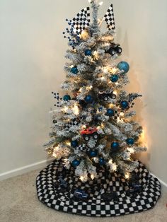 a white christmas tree with blue and silver ornaments