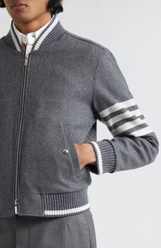 This classic wool bomber jacket is kissed with cashmere and designed with tipped sweater-gauge ribbing and the iconic 4-Bars encircling the left sleeve. 24" length (size 2) Two-way front-zip closure Blade collar Front snap welt pockets Ribbed cuffs and hem Stripe lining 95% wool, 5% cashmere Dry clean Made in Italy Designer Clothing Luxury Varsity Jacket For Winter Workwear, Luxury Winter Varsity Jacket For Workwear, Luxury Varsity Jacket With Padded Collar For Fall, Classic Wool Outerwear With Ribbed Collar, Luxury Winter Varsity Jacket With Padded Collar, Luxury Cashmere Outerwear, Classic Winter Varsity Jacket With Ribbed Collar, Classic Winter Varsity Jacket With Ribbed Cuffs, Classic Cashmere Outerwear With Ribbed Collar