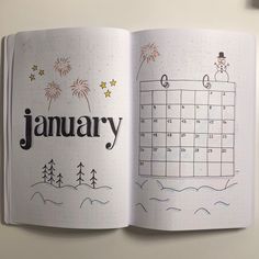 an open notebook with the word january written on it and fireworks in the sky above