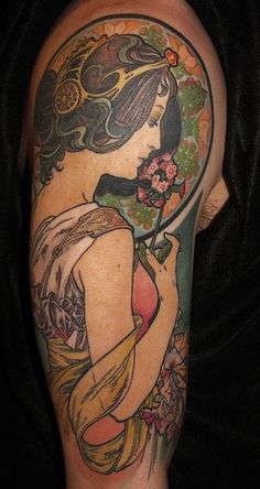 a woman with a flower in her hair is shown on the back of a man's arm