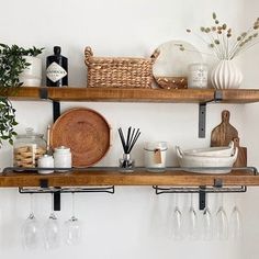 two wooden shelves with wine glasses, plates and utensils