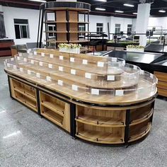 an empty room with many shelves and tables on the floor, all lined up in rows