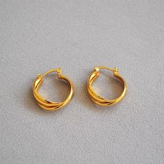 [MATERIAL]: 18K gold plated on yellow brass and needles are surgical steel and hypoallergenic.[HOOP SIZE]: 25mm Gold Earring Aesthetic, Minimal Hoop Earrings, Twist Hoop Earrings, Clean Sterling Silver, Earrings Minimal, Letter Earrings, Initial Earrings, Artisan Earrings, Tiny Studs