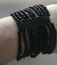 Very nice Ten strands of tiny black beads on elastic to firm cuff bracelet. Stretches up to seven inch wrist. Tight elastic. Victorian or goth style. Handmade Adjustable Black Stretch Bracelet, Adjustable Handmade Black Stretch Bracelet, Black Beaded Stretch Bracelet For Party, Adjustable Black Stretch Bracelet With Spacer Beads, Gothic Bracelet, Victorian Goth, Goth Style, Jan 17, Glass Beaded Bracelets