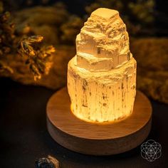 an illuminated rock sitting on top of a wooden stand