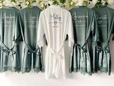 three robes hanging up against a wall with flowers