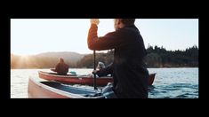 two people in small boats on the water