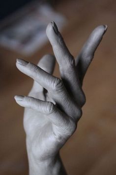 a person's hand making the v sign with their fingers