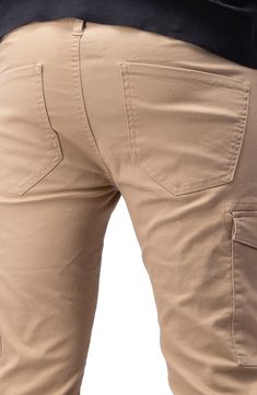 Solid chino pants constructed from comfortable stretch twill feature roomy cargo pockets for contemporary style. 13" leg opening; 9 3/4" front rise (size 32x32) Zip fly with button closure Five-pocket style Leg cargo pockets Skinny leg Stretch twill construction 64% cotton, 33% polyester, 3% spandex Machine wash, tumble dry Imported Model stats: 6'1" height, 32" waist. Model is wearing size 32x32. Leg Stretching, Chino Pants, Chinos Pants, Nordstrom Rack, Contemporary Style, Nordstrom, Pants, How To Wear, Trousers