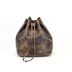 a brown leather handbag on a white background