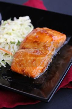 salmon and cole slaw on a black plate