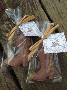 two brown cowboy boots are wrapped in plastic and tied with twine on top of each other