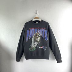 Vintage 1995 New England Patriots NFL Crewneck Sweatshirt Team Sportswear  Condition : Used vintage Good conditions Details : defect on fabric                Stains, 6 little holes                 (Look at the picture) Please Let me know if you have any      questions or More Photo Detail Brand : Fan Sportswear Made in : USA  Measurement Size On Tag : L, (fit like M) Pit to pit : 21.5 inches Length : 27 inches Material : Cotton Polyester Color : Black (nice faded)  *Please keep in mind that our items are vintage so they may show some signs of wear and tear *Please read everything before buying  No Cancel  No Refund  No Return  payment Accept PayPal only. Please give us your phone number together with address after you purchasing.( No P.O Box  shipping to worldwide Item will shipped in 1-3 90s Sport, Cowboys Hoodie, Fabric Stains, New England Patriots, College Outfits, New England, Crewneck Sweatshirt, Nfl, Crew Neck Sweatshirt