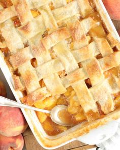 a close up of a pie on a table with peaches