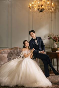 a man in a tuxedo sitting next to a woman in a wedding dress