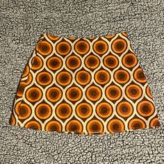 Nwot Cider Mini Skirt, Size Medium, Retro Pattern, Brown/Orange/Amber/Cream Colored, Polyester Material, No Stretch Retro Fitted Brown Skort, Orange Retro Mini Skirt, Retro Orange Summer Skirt, Orange Fitted Retro Mini Skirt, Fitted Retro Orange Mini Skirt, Retro Orange Mini Skirt, Orange Casual Mini Skort, Retro Brown Skort For Spring, Casual Orange Mini Skort