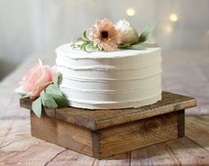 a white cake sitting on top of a wooden box