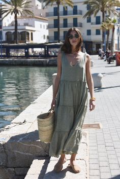 Style // A subtle, soothing and summer infused sage green linen maxi dress V-neck line and low back dress, The Sevilla Dress is a true goes-with-anything essential, guaranteed to turn heads in this timeless linen maxi dress with tie closures at the shoulders, and a tiered body for added dimension and versatility. With that perfect flowy and relaxed fit, the stunning Sevilla Dress was designed to be dressed up with a strappy sandal or barefoot for that effortlessly beautiful look! Fabric Note // Linen V-neck Sundress Maxi Dress, Chic Linen Maxi Dress For Summer, Chic Linen Maxi Dress For Day Out, Chic Maxi Linen Dress For Brunch, Linen Maxi Dress For Vacation, Sage Dresses For Summer Beach, Bohemian Linen Maxi Dress For Day Out, Linen Sundress Maxi Dress For Brunch, Linen Chic Maxi Dress