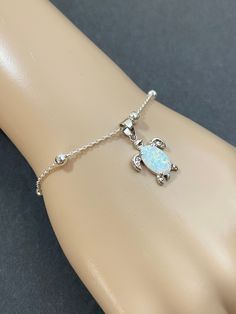 "Sterling Silver Adjustable Opal Turtle Bracelet Dainty Beaded Bracelet With Opal Turtle Charm Stone: Lab created opal Metal: All Components Are Made From Solid .925 Sterling Silver **Choose Bracelet Size At Checkout** XSmall~Adjustable from 6\"-7\" Small~Adjustable from 6.5\" - 7.5\" Medium~Adjustable from 7\" - 8\" Large~Adjustable from 7.5\"-8.5\" **To Determine Bracelet Size: Measure wrist Snug then add 0.5\" . Bracelets are made with 1\" EXT chain so they can accommodate different wrist siz Adjustable Beaded Opal Bracelet, Adjustable Hand-strung Opal Jewelry, Opal Beaded Bracelets For Gifts, Dainty Adjustable Opal Bracelet, Adjustable Opal Bracelet Gift, Adjustable Opal Bracelet For Gift, Adjustable Opal Spiritual Bracelet, Elegant Adjustable Opal Beaded Bracelets, April Birthstone Necklace