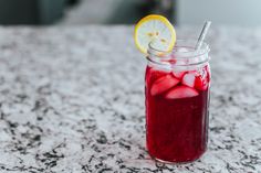 a mason jar filled with ice and lemon slices