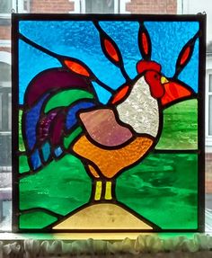 a stained glass window with a rooster on it