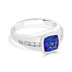 This Ring That Is Artistically Styled With 14k White Gold Makes A Standout. Featuring A Classy Design That Shines Bright With Cushion-cut Tanzanite And Round Diamonds, This Ring Will Embody Ethereal Perfection To Your Look. Product Information SKU ADG50597/8 Metal Type 14K Metal Color White Gold Ring Style Solitaire Primary Stone Gemstone Name Tanzanite Gemstone Species Zoisite No. Of Gemstones 1 Gemstone Shape Cushion Gemstone Weight 2.23 Gemstone Size 8x8 Origin Tanzania Secondary Stone Gemsto Timeless Tanzanite Ring With Round Cut, Timeless Tanzanite Round Cut Ring, Timeless Tanzanite Round Rings, Tanzanite Cushion Cut Ring With Brilliant Detail, Brilliant Cut Tanzanite Diamond Ring For Anniversary, Formal Diamond Sapphire Ring Channel Set, Formal Sapphire Ring With Channel Set Diamonds, Formal Cushion Cut Rings With Accent Stones, Formal Cushion Cut Ring With Accent Stones