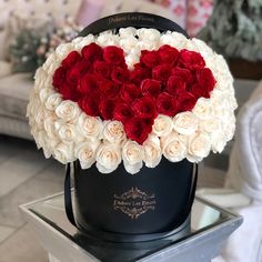 a heart - shaped box with roses in the shape of a heart is on display