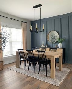 a dining room table surrounded by black chairs