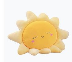 a yellow sun pillow with eyes closed