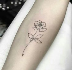 a single rose tattoo on the arm