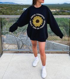 Spread positivity in style with this Grow Through What You Go Through Unisex Sweatshirt! Made from a comfy and cozy fabric, this relaxed fit crew neck sweater will keep you warm and snug. Featuring a beautiful sunflower print and a powerful quote to inspire and motivate, this is one sweatshirt you won't want to miss out on! 🌻 This product is made especially for you as soon as you place an order, which is why it takes us a bit longer to deliver it to you. Making products on demand instead of in Spring Graphic Print Crew Neck Sweats, Sunflower Sweatshirt, Cheap Sunflower Design Crew Neck T-shirt, Crew Neck Cotton T-shirt With Sunflower Design, Sunflower Print Crew Neck Graphic Tee, Sunflower Print, Oversized Sweatshirt, Powerful Quotes, Floral Shirt