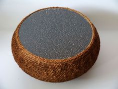 a brown and black round object sitting on top of a white table